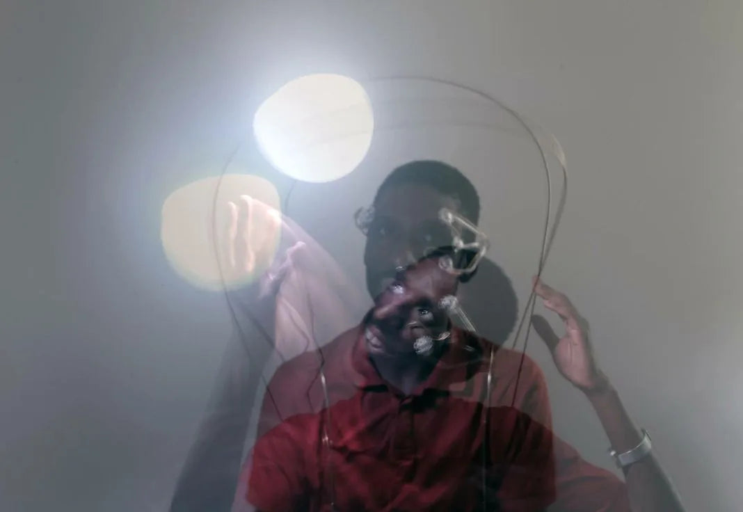 A visitor in the personal light installation, lit by moving light sources